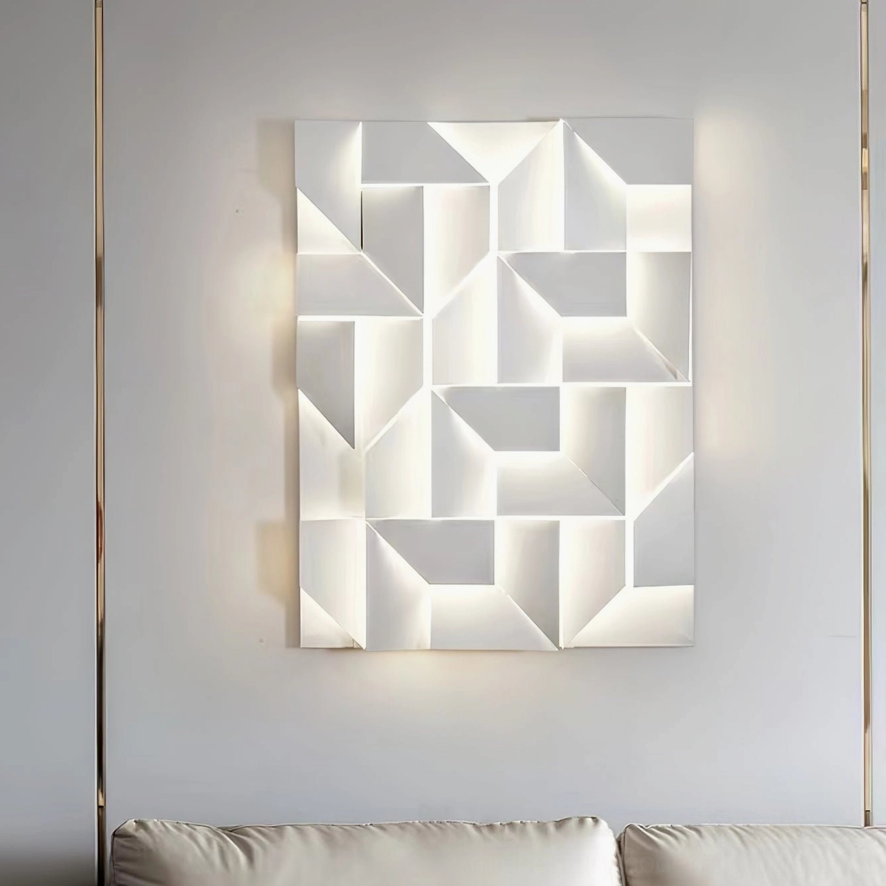 Abstract geometric wall sconce with soft white LED backlighting above sofa, minimalist interior design