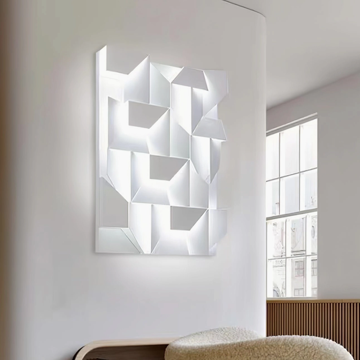 Vertical rectangular geometric wall sconce with LED backlit white finish in bright residential room