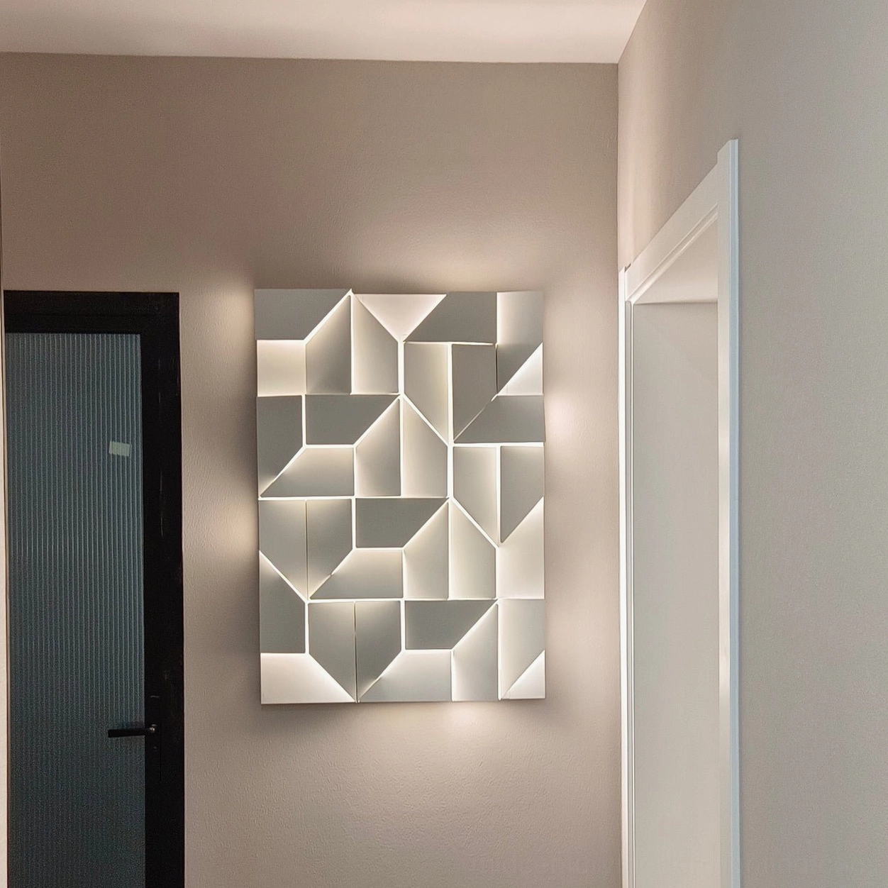 Shadows wall sconce with 3D geometric aluminum frame, warm backlit LED illumination