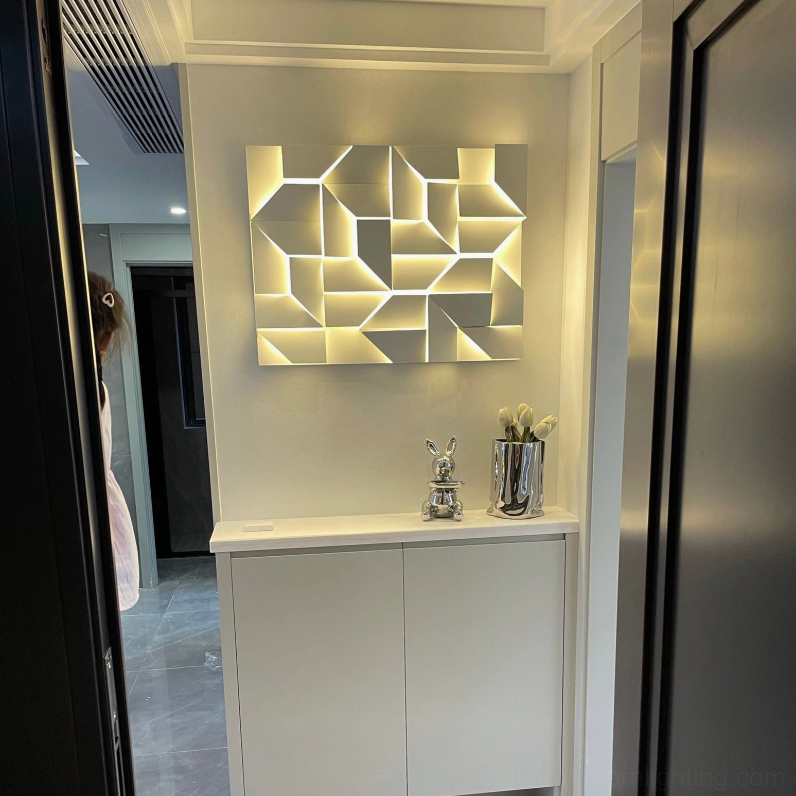 Shadows wall sconce with abstract geometric pattern, warm integrated LED lighting