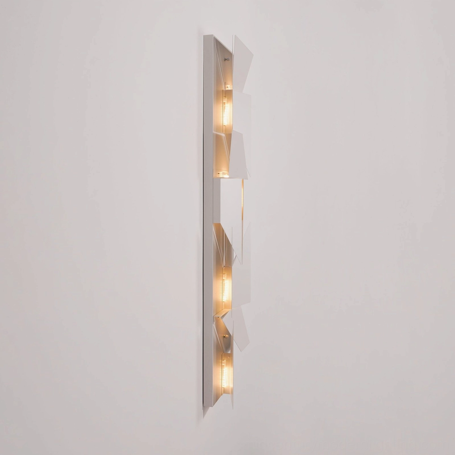 Wall sconce geometric cutout pattern, warm integrated LED lighting modern