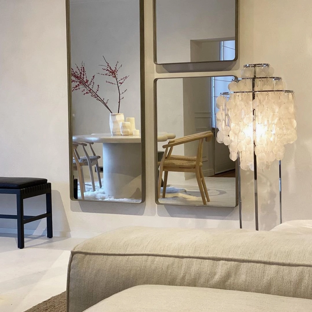 Bright white capiz shell floor lamp with reflective design elements in modern dining nook