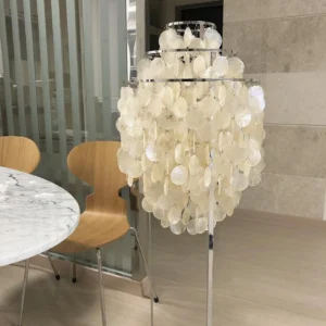 Modern shell floor lamp with warm white capiz shells and polished chrome frame in contemporary dining space