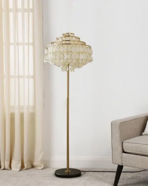 Side profile of tiered capiz shell floor lamp in minimalist living room with sofa