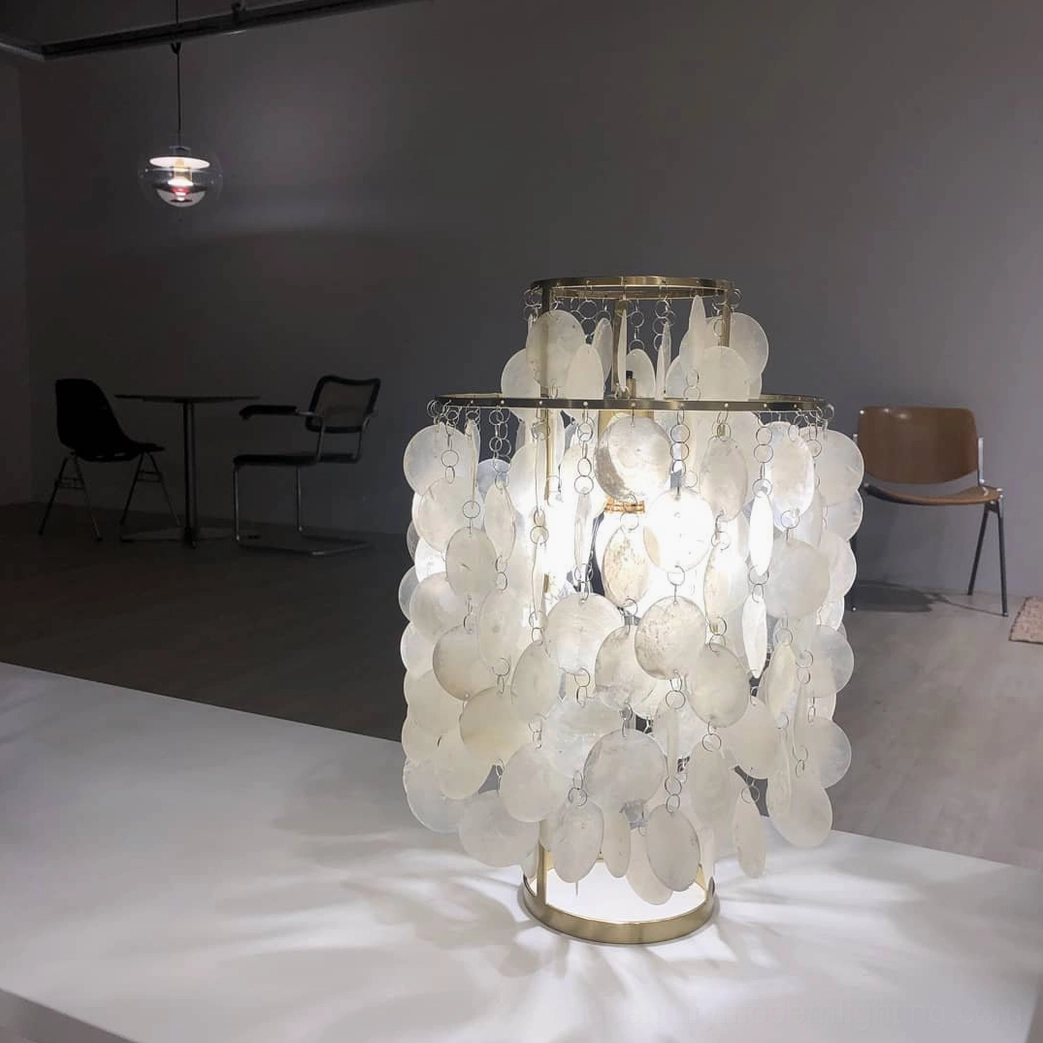 Mother-of-pearl shell table lamp glowing in elegant modern living room setting