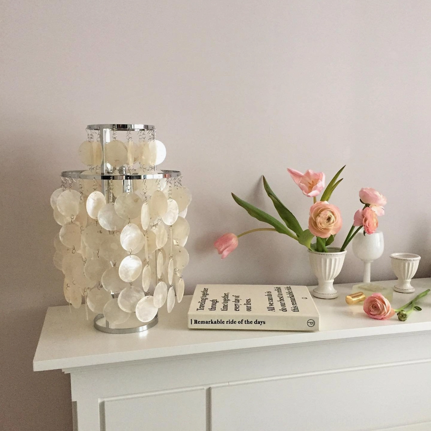 Capiz shell table lamp creating layered ambient lighting in home interior