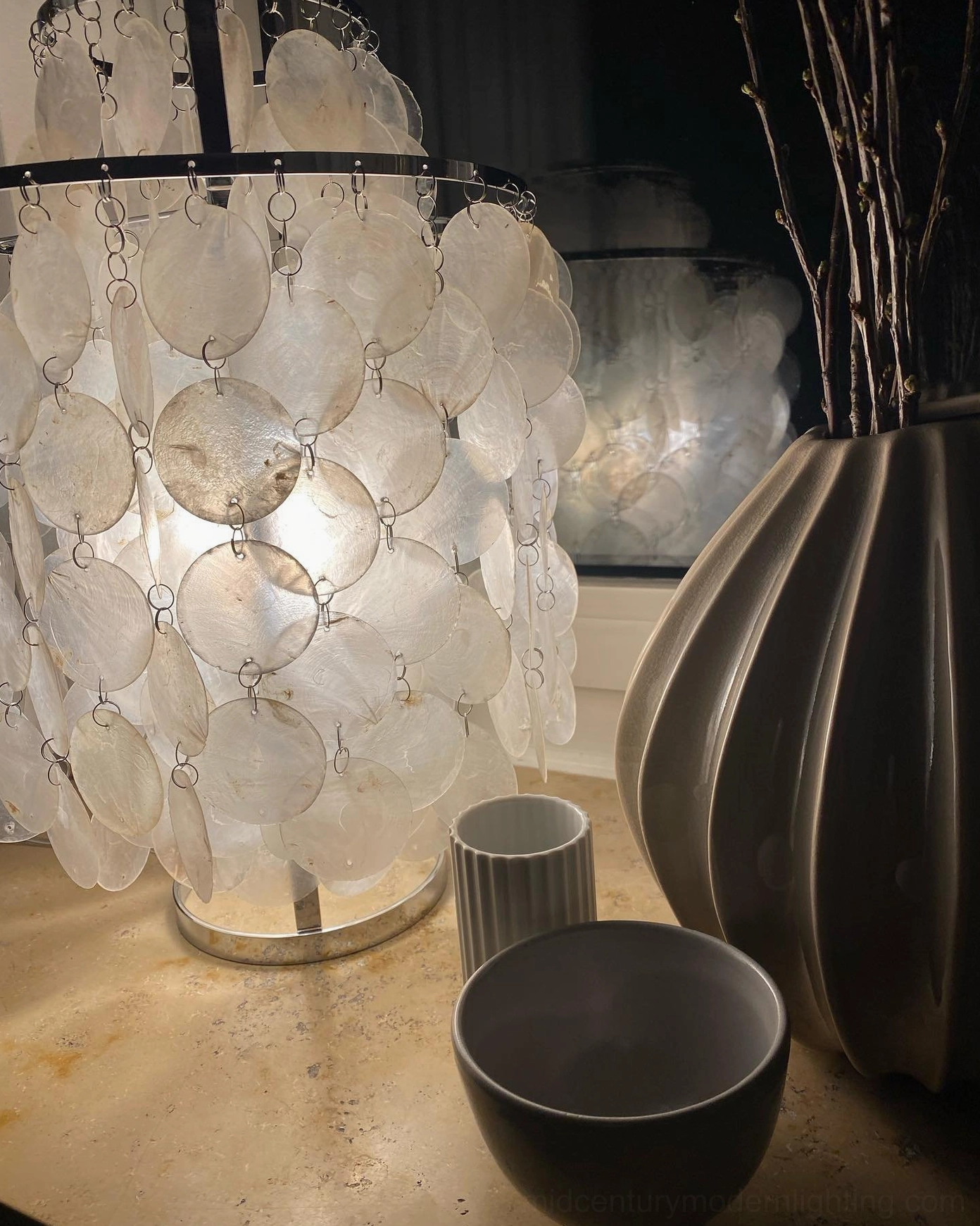 Contemporary shell table lamp with natural light through pearl material