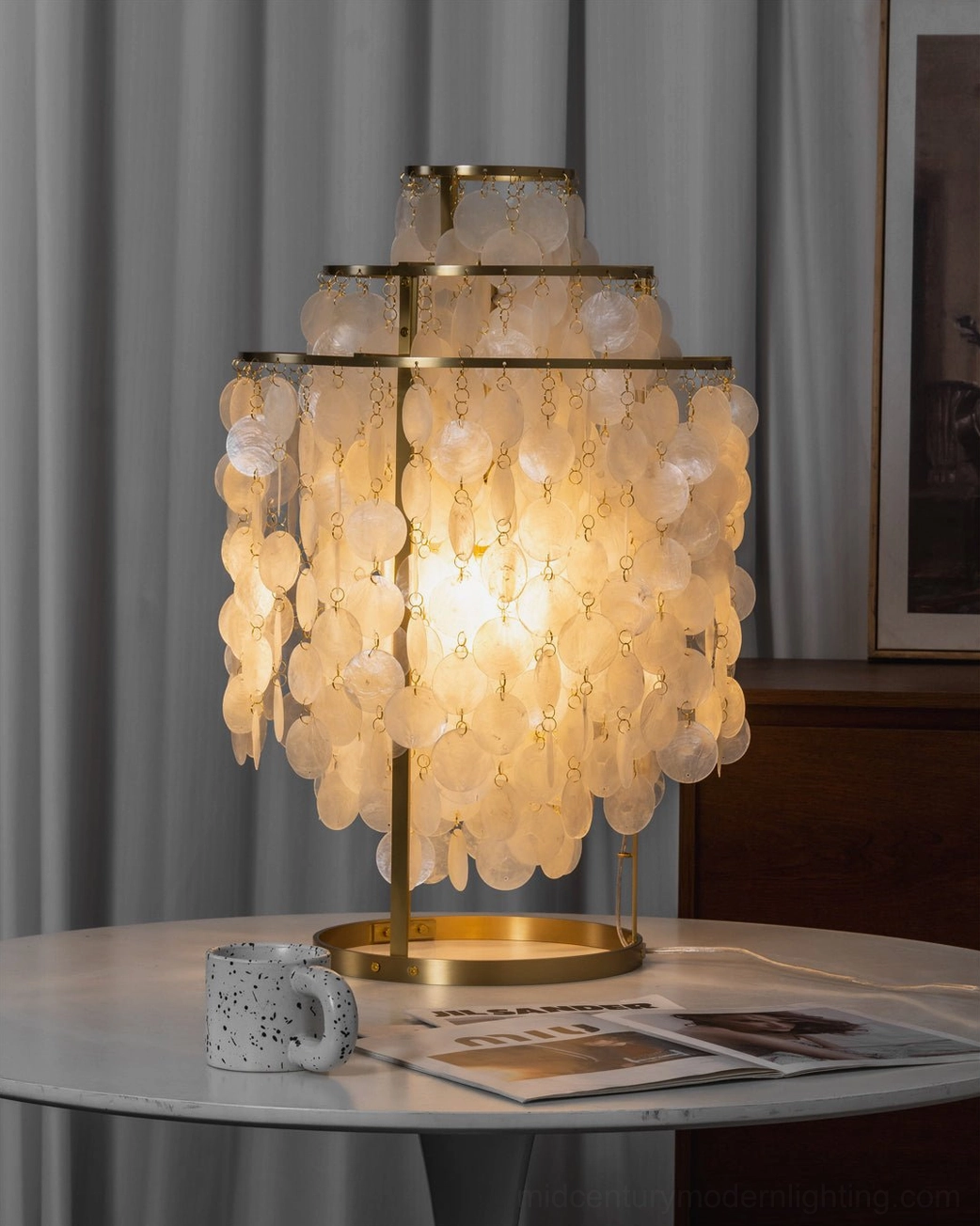 Capiz shell table light glowing in classic home interior with magazine and coffee mug