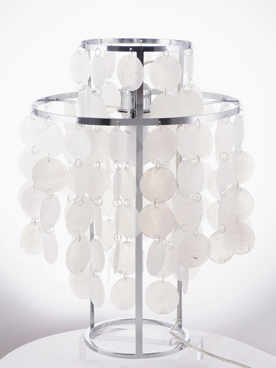 Luxury mother-of-pearl shell table lamp with warm golden light ambiance