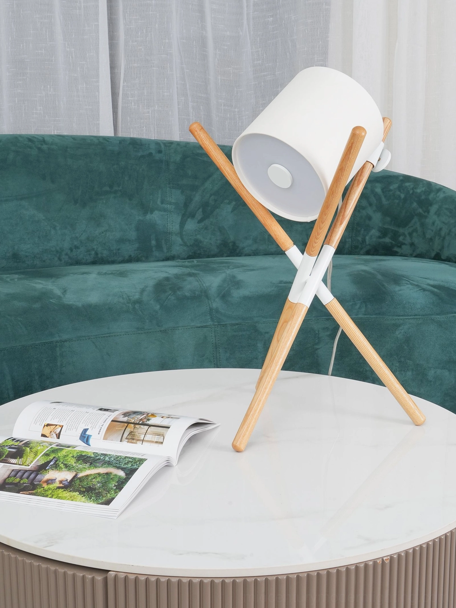 Natural wood tripod base table lamp with contemporary shade in modern home setting
