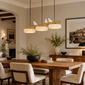 Modern linear alabaster chandelier with three birds and glowing stone discs above traditional dining table
