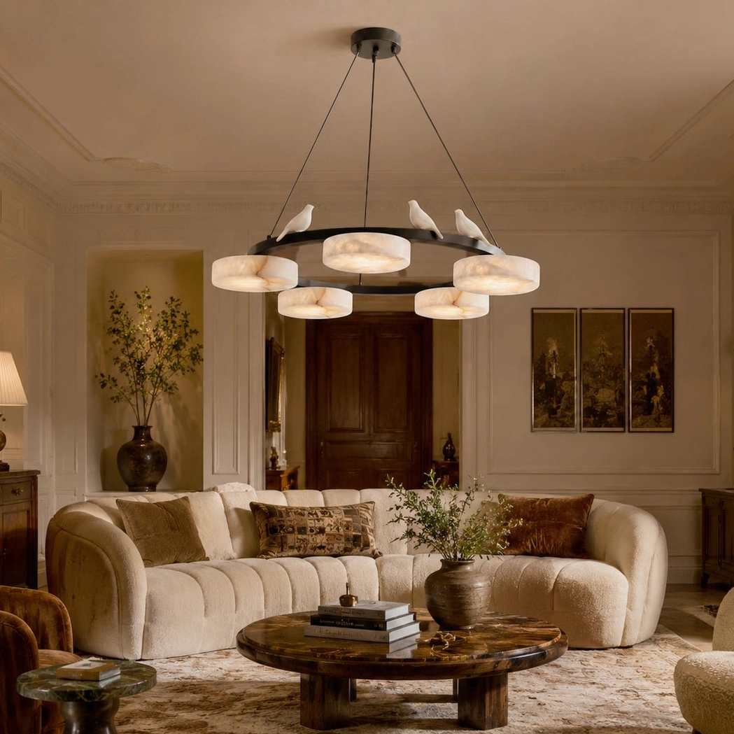 Sienna Bird chandelier installed in warm beige modern living room, casting soft diffused light through alabaster shades