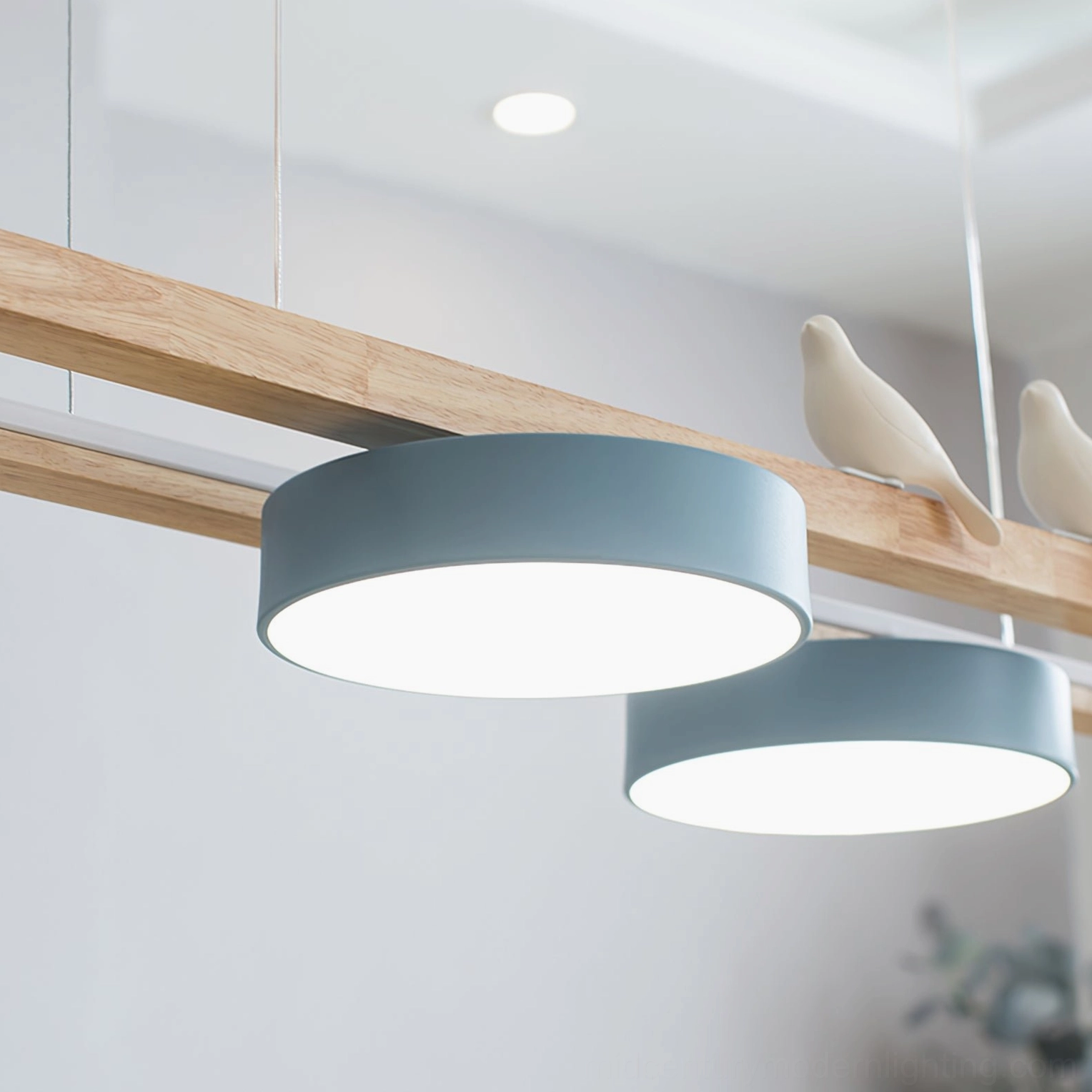 Low-angle side view of Sienna Bird Chandelier with blue-grey shades in residential setting