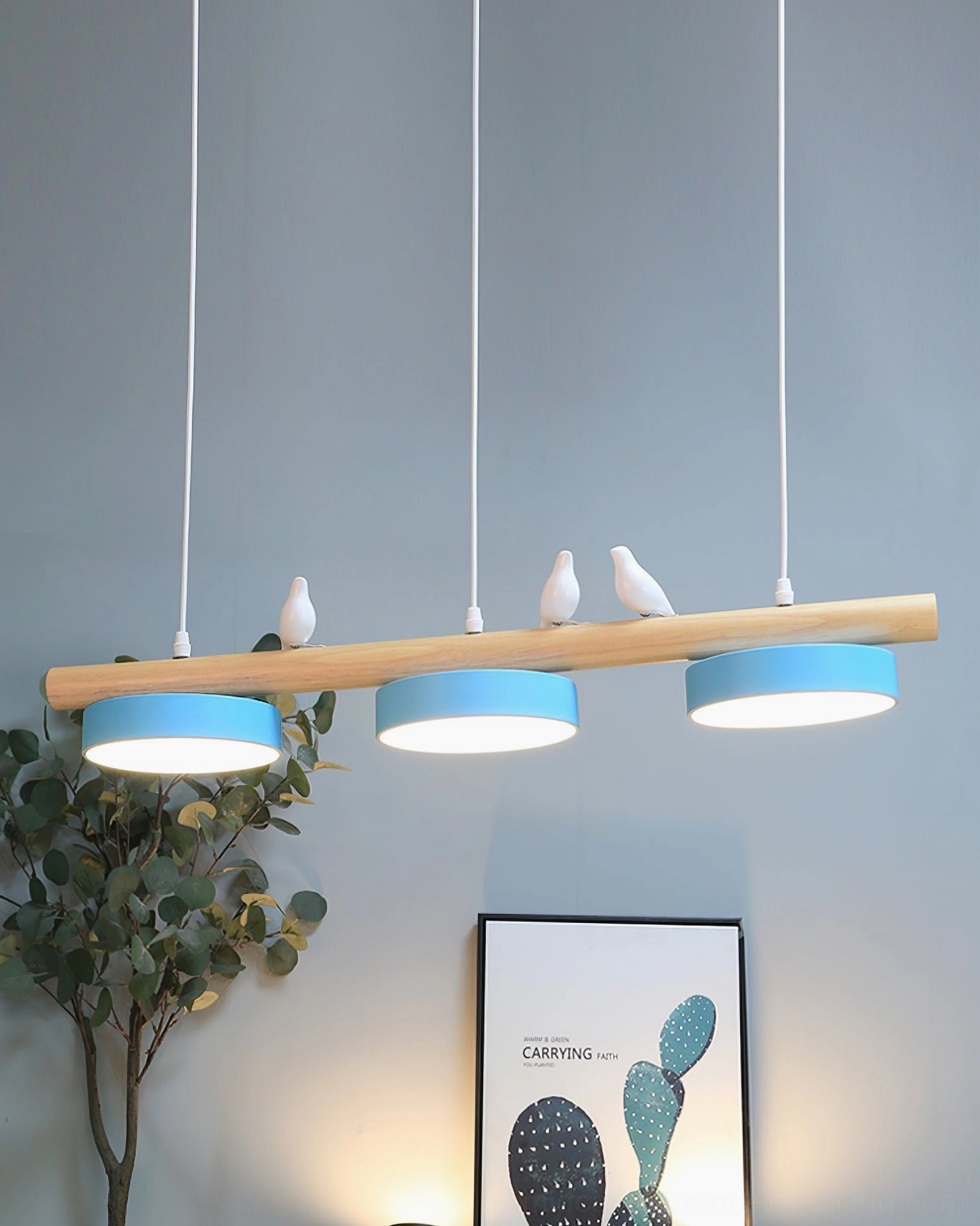 Linear pendant light with adjustable bird sculptures displayed in home interior setting