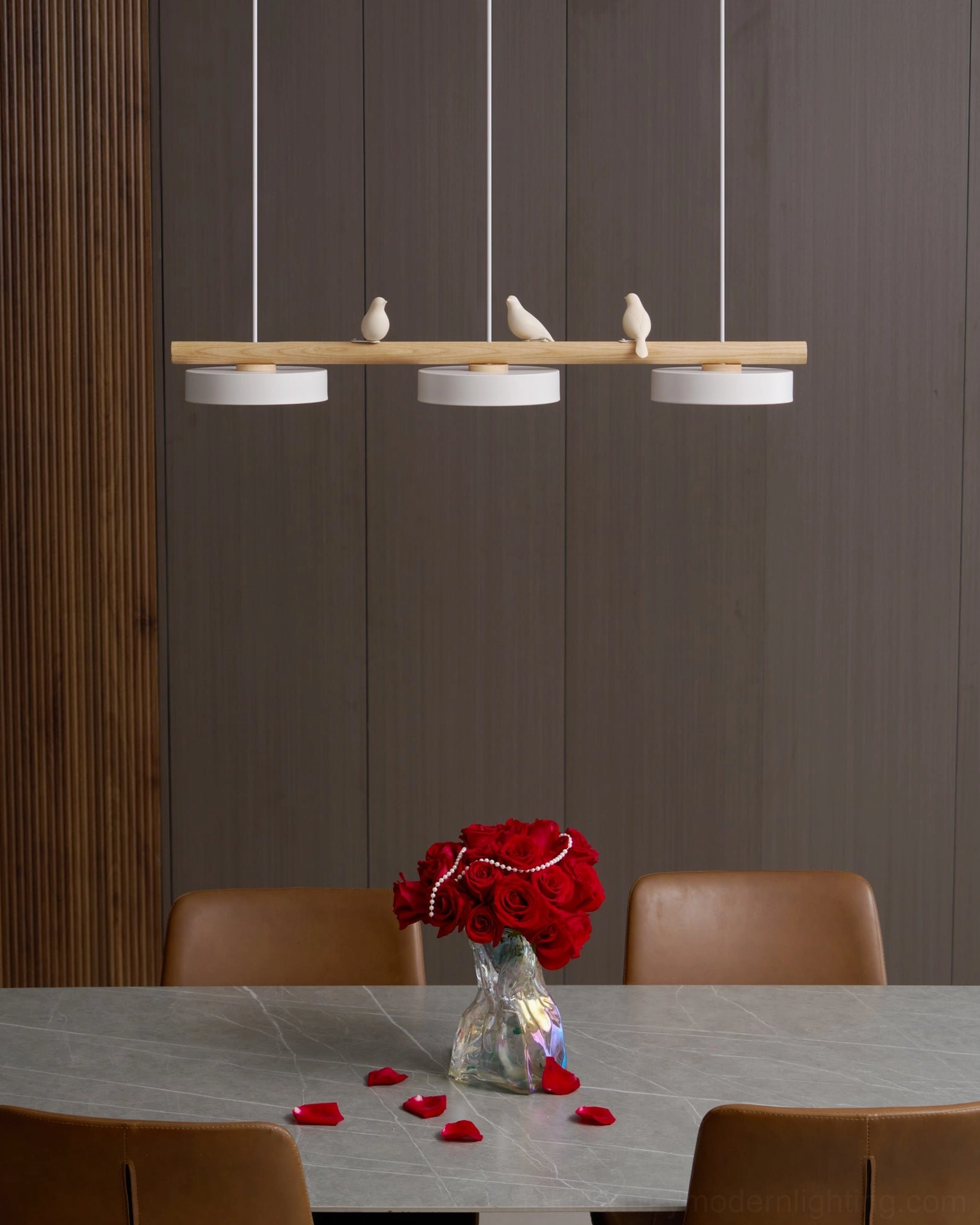 Linear bird pendant lamp showing warm color temperature and sculptural aesthetic