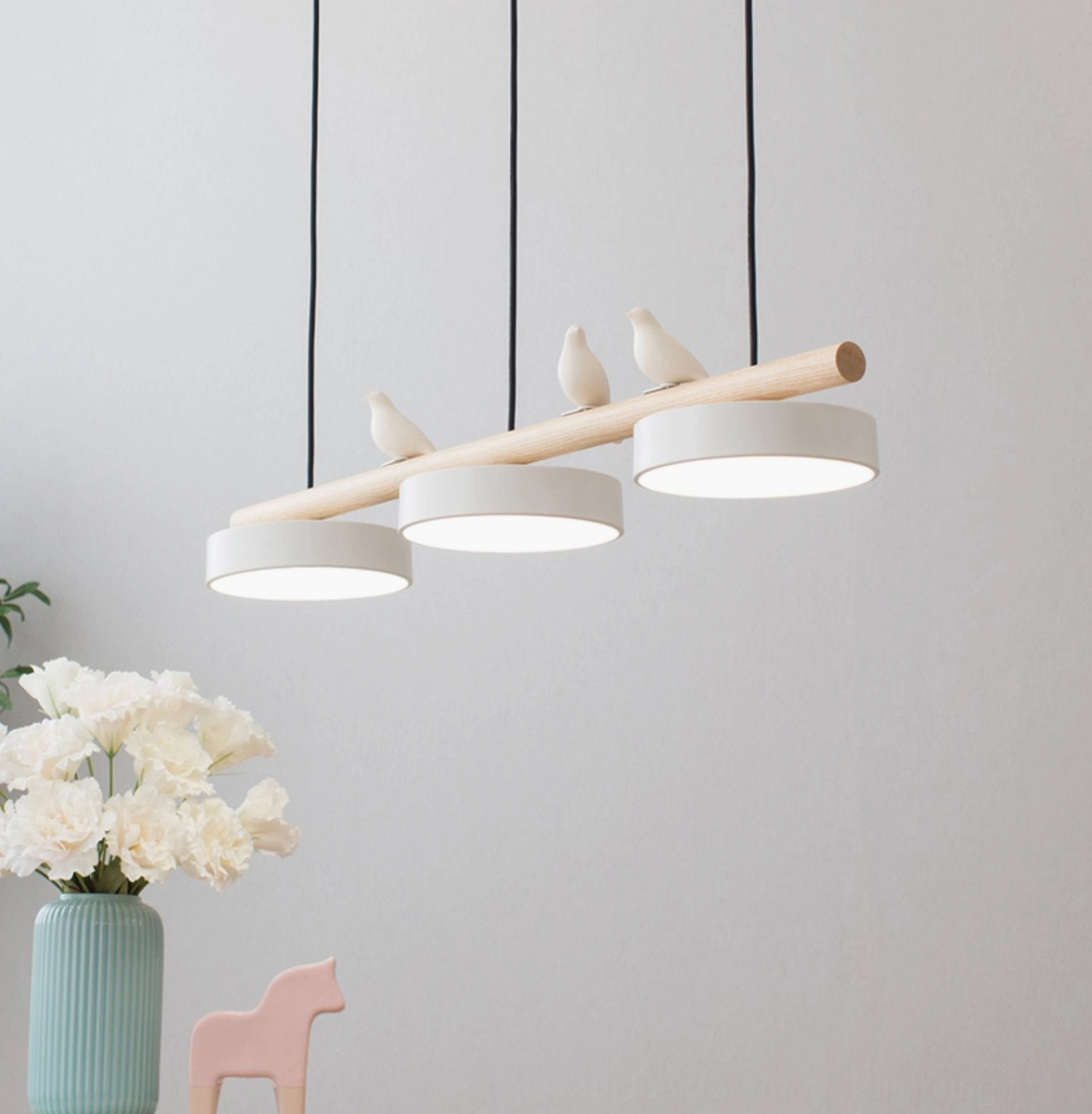 White resin bird pendant lamp close-up side view with minimalist Nordic styling