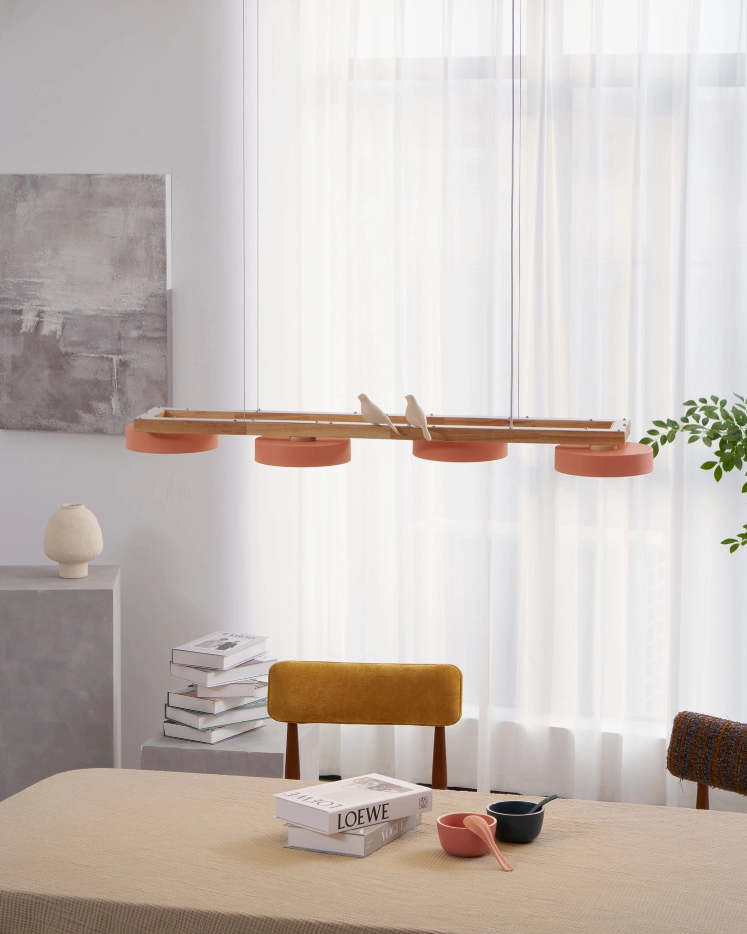 Eye-level close-up of pink Sienna Bird Chandelier showing LED warm white light and wooden details