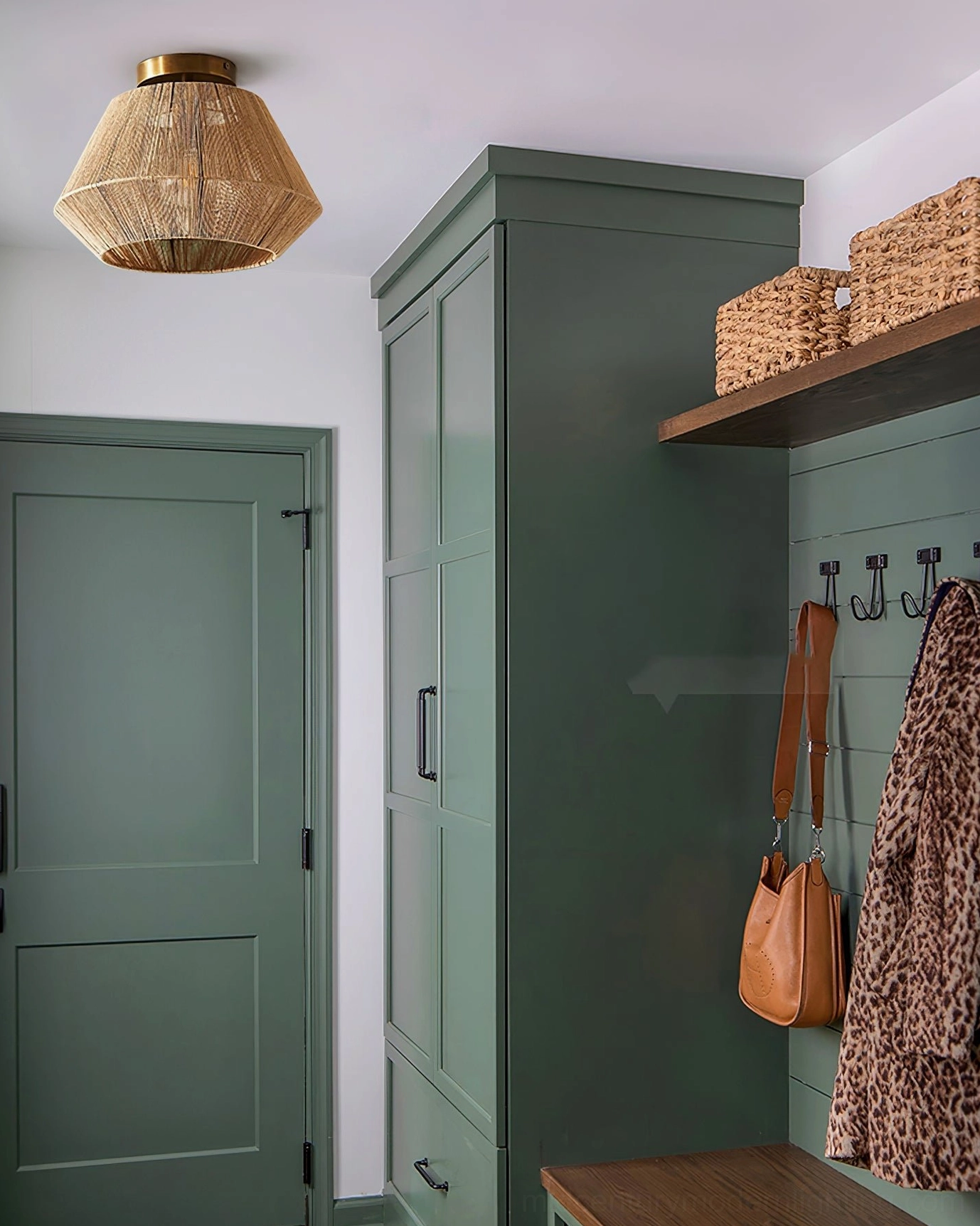 Sierra rattan ceiling light in green farmhouse room with coat storage and rustic charm