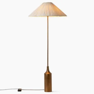 Sierra pleated linen floor lamp, left side profile view, showcasing the tapered cast metal gold base and wide umbrella-shaped white linen shade with knife pleats
