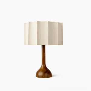 Sierra mid-century modern table lamp with solid walnut turned wooden base and pleated beige fabric shade, studio front view