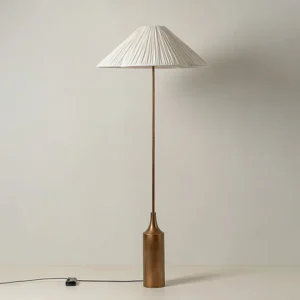 Sierra mid-century modern floor lamp, direct front view, displaying the sculptural proportions of the knife-pleated white linen shade and matte gold cast metal pedestal