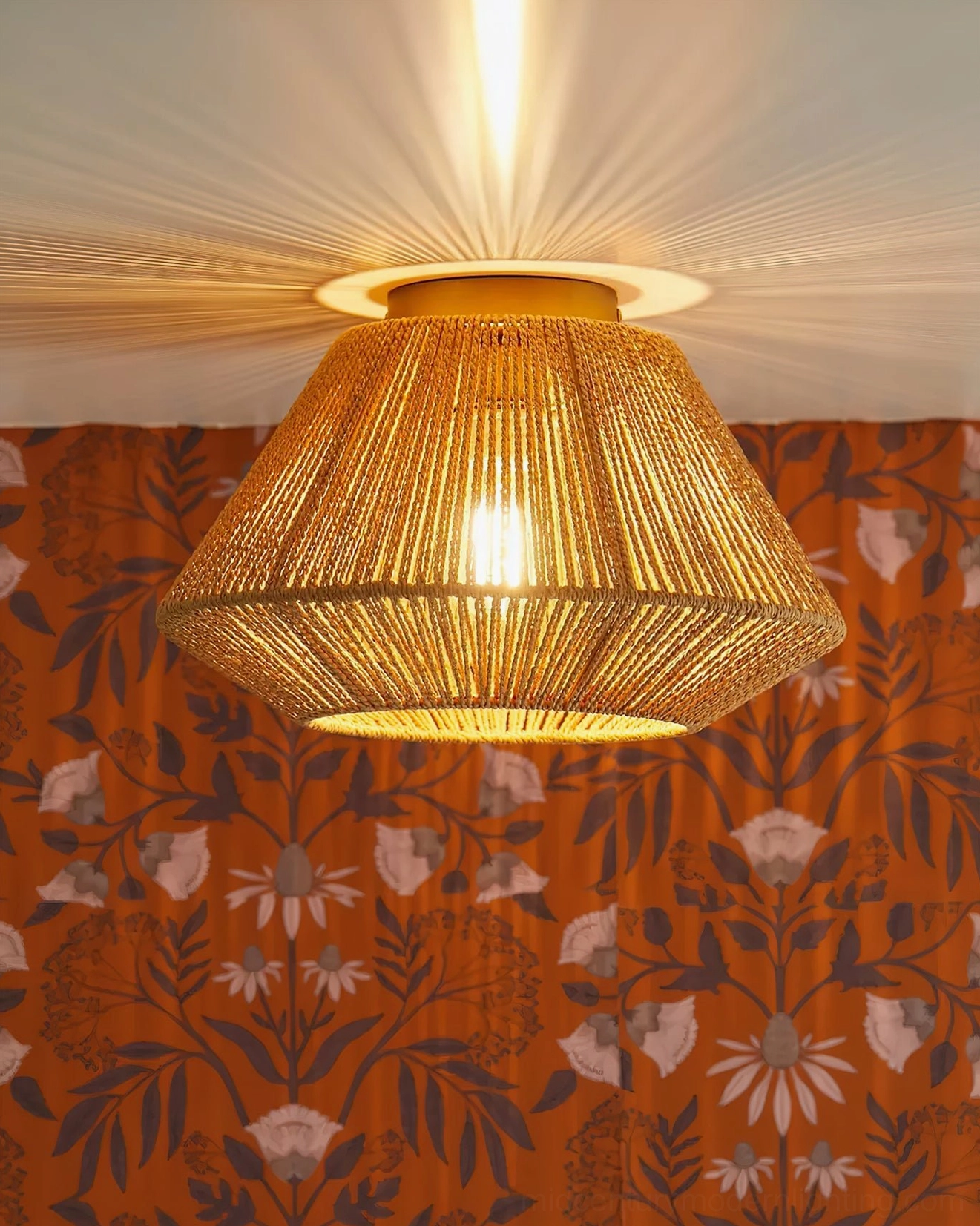 Sierra rattan flush mount ceiling light creating warm ambient lighting in bohemian room setting