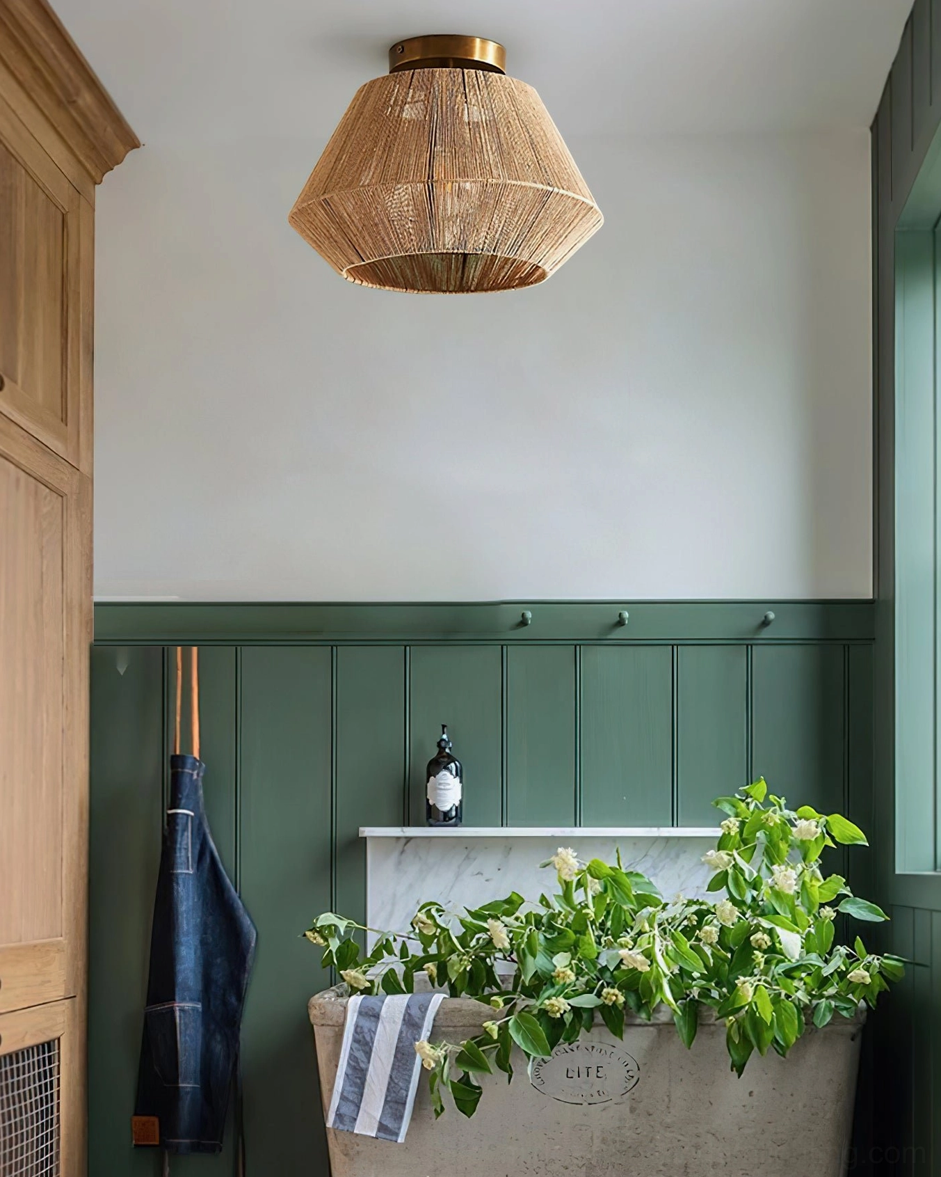 Sierra flush mount light fixture in vintage laundry room with green wainscoting walls