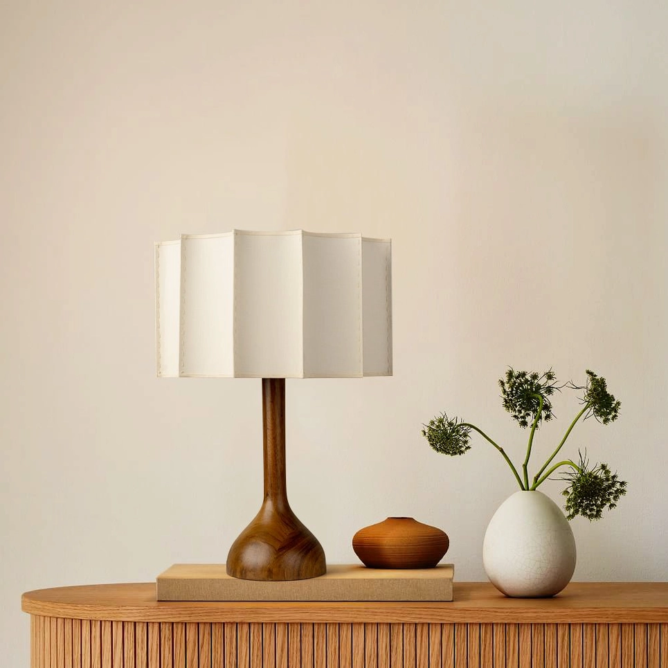 Sierra wooden table lamp paired with ceramic vase on console table in boho mid-century modern bedroom setting