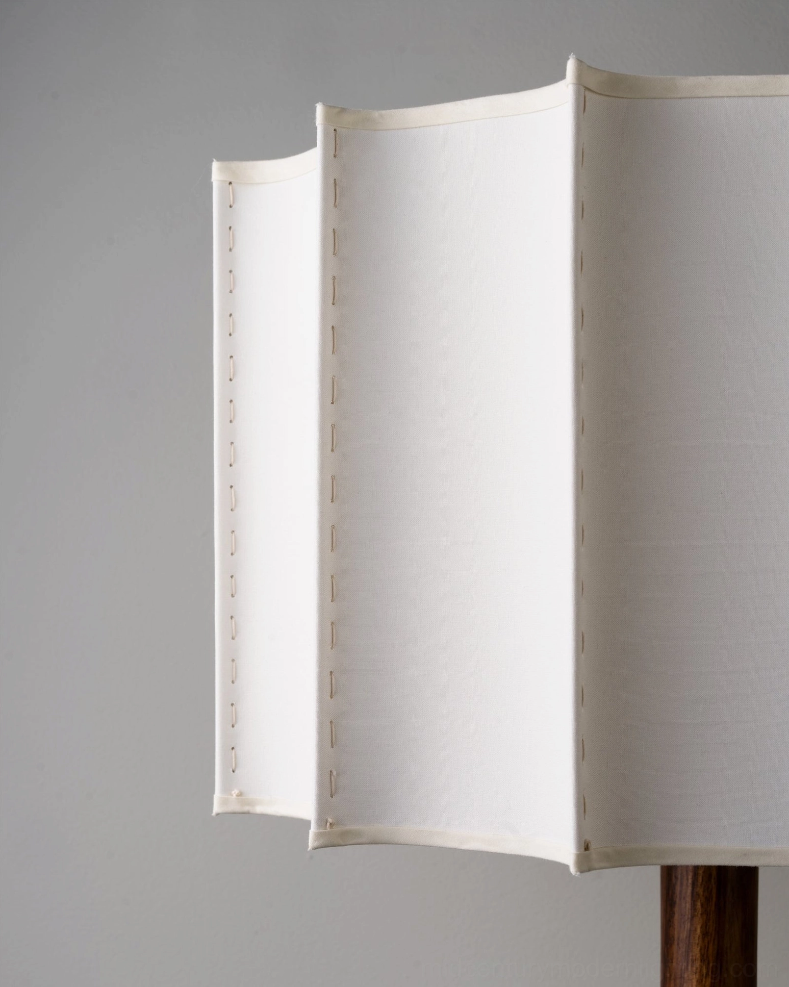 Close-up detail of Sierra table lamp pleated beige fabric shade showing fine stitching and texture craftsmanship