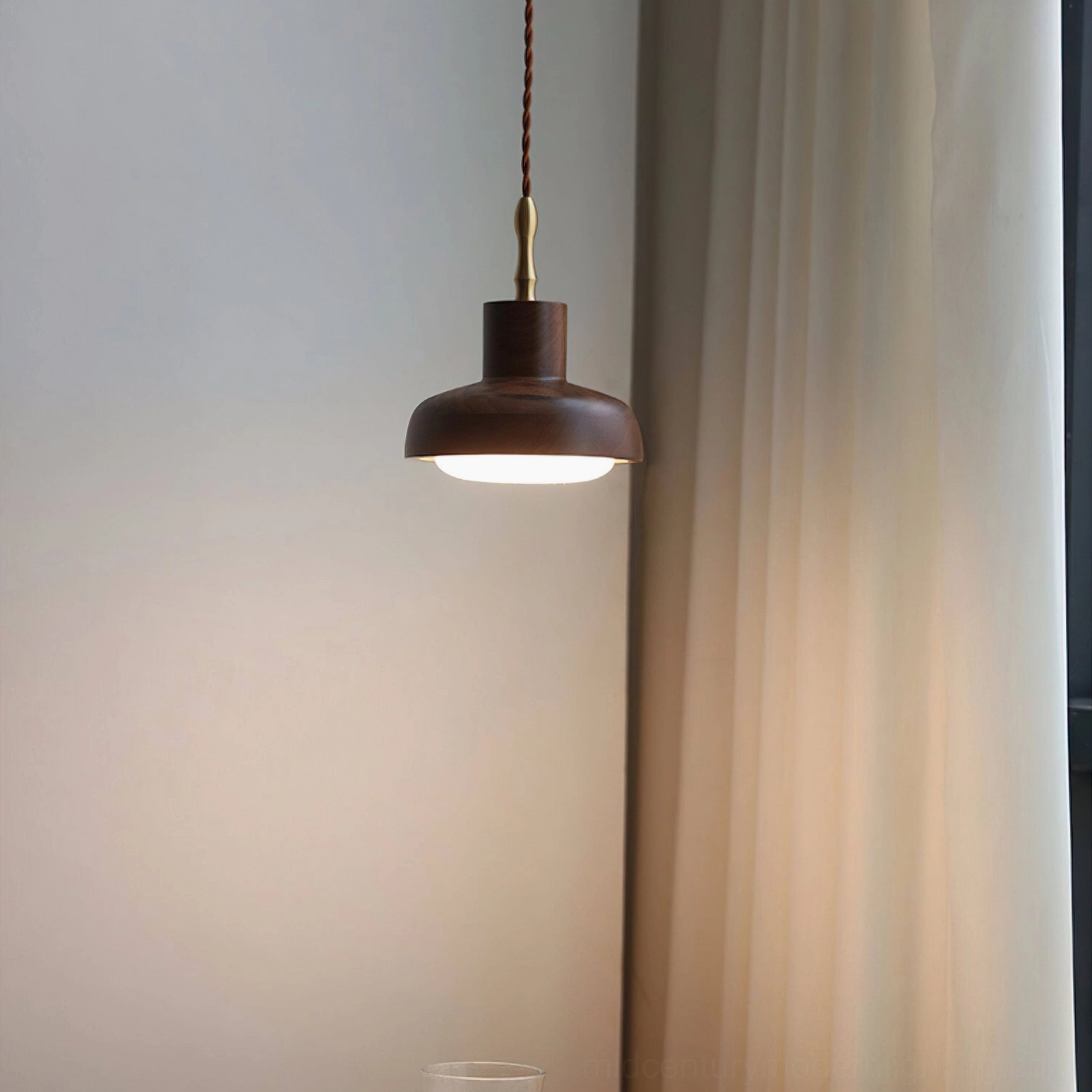 Lit silas walnut pendant casting warm directional light in bedroom corner with draped curtains and small glass, intimate lighting mood