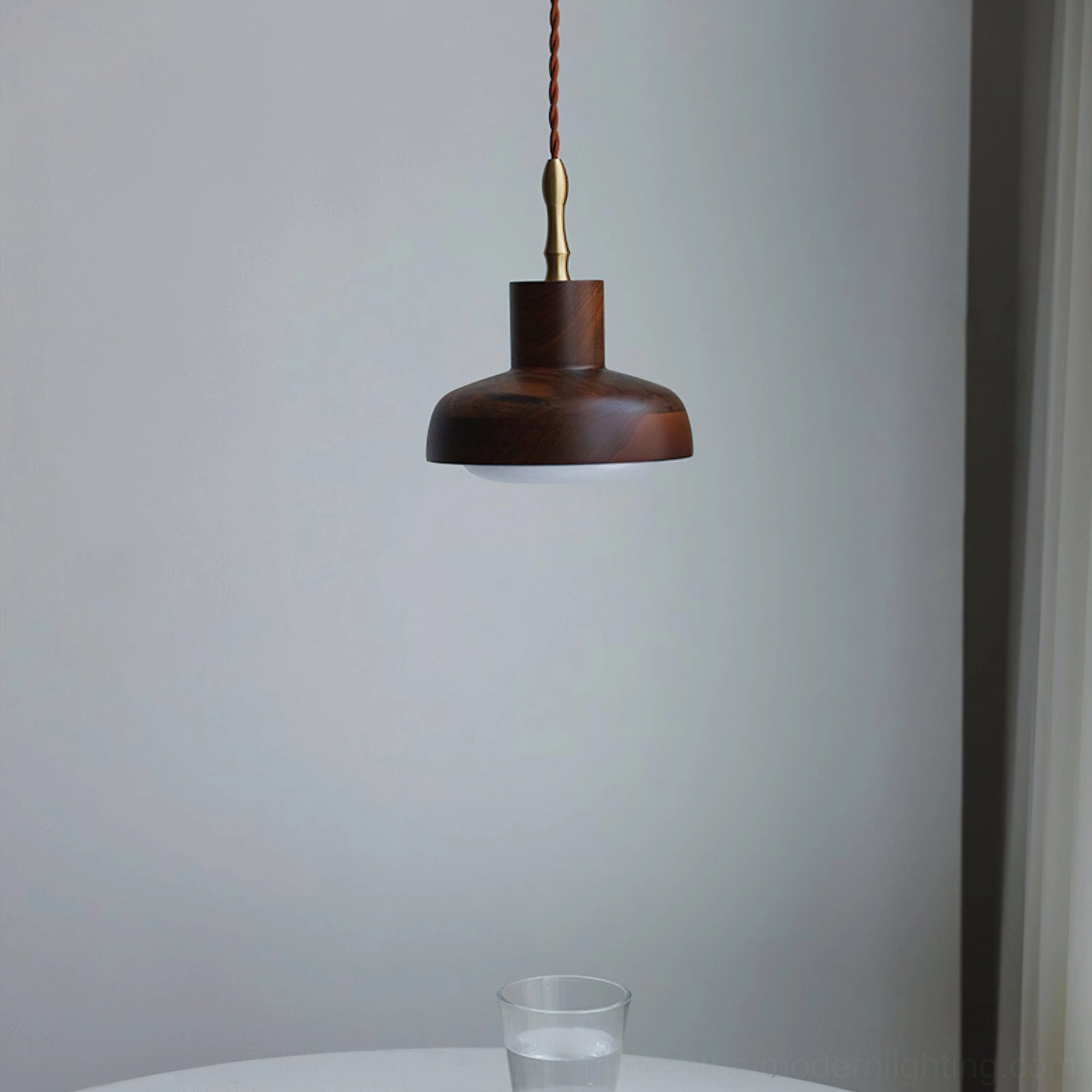 Unlit silas walnut pendant from side profile against plain wall with partial curtain backdrop, geometric dome silhouette with glass accent