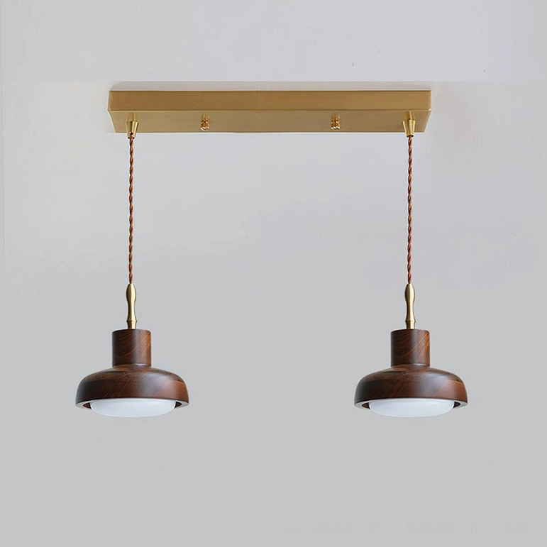 Single silas walnut pendant light isolated on neutral background emphasizing solid dome form and suspension hardware