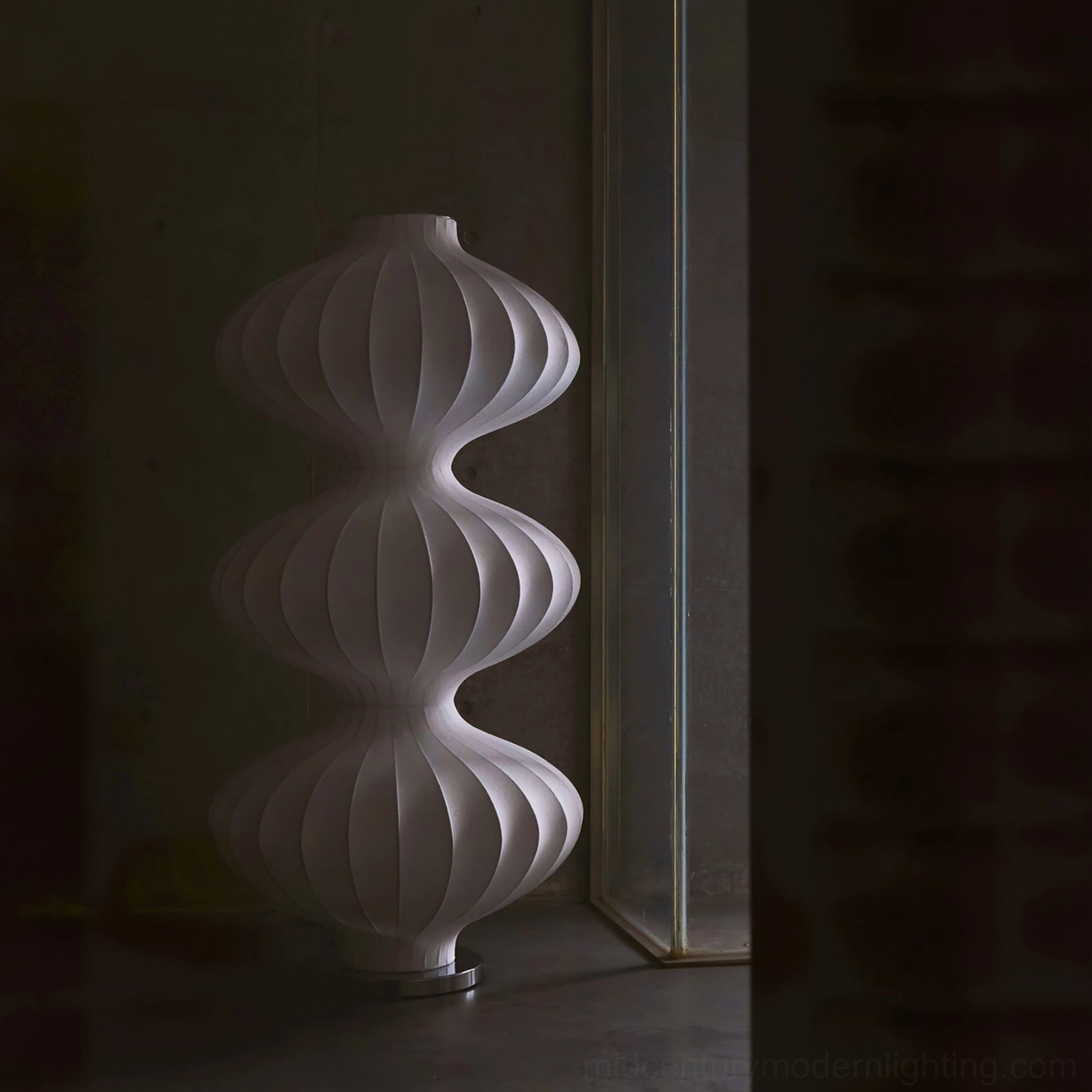 White silk gourd floor lamp three-quarter side view in dim lighting, minimalist sculptural design