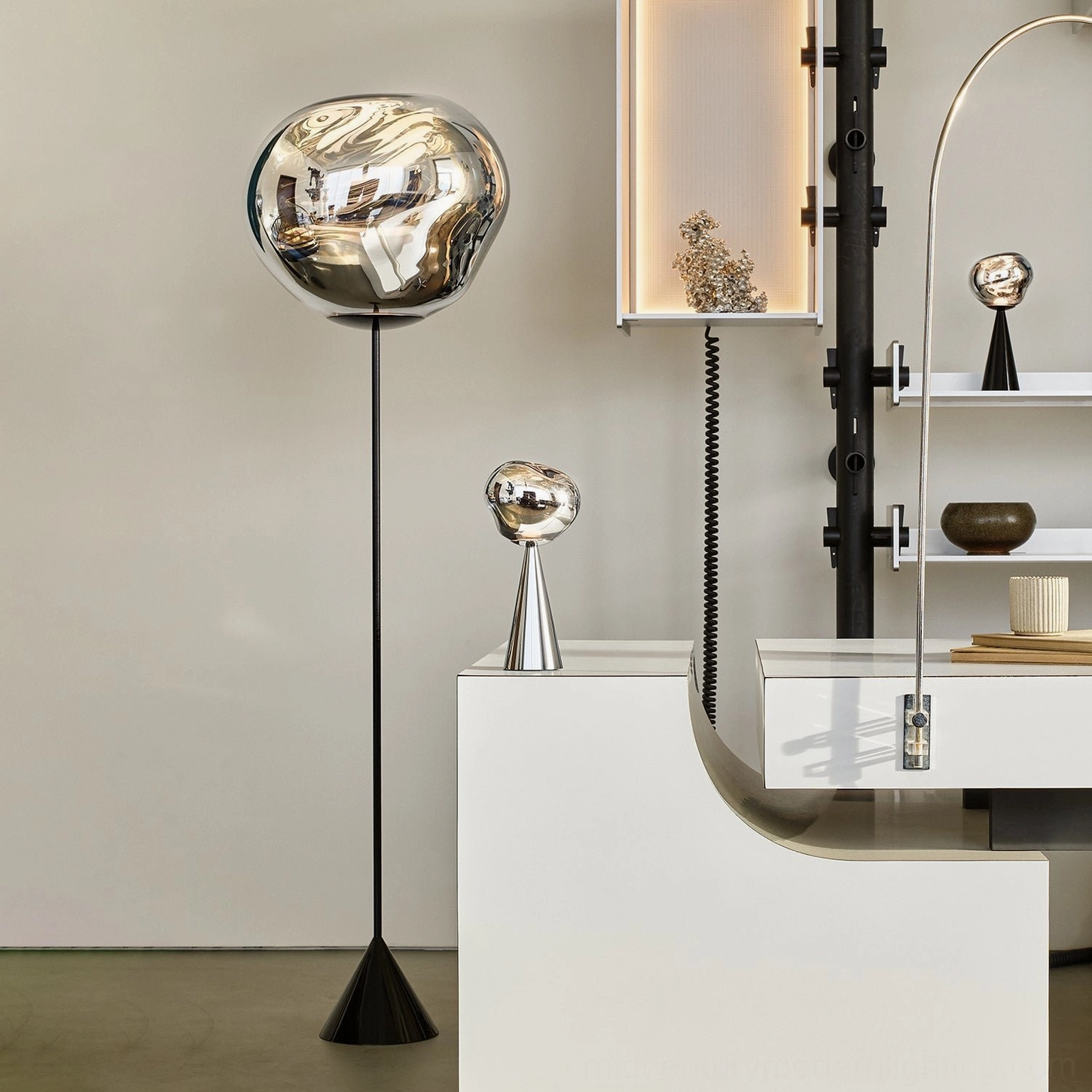 Silver Lava Slim Floor Lamp in design showroom with matching miniature lamp decor, modern sculptural lighting display