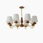 Simone wood and brass 6-light chandelier with pleated white shades, front studio view showing sculptural walnut column and curved brass arms