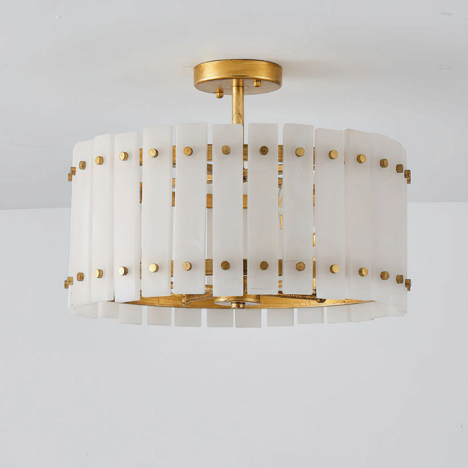 Close-up detail of Sinclair alabaster ceiling light showing brass stud fasteners and vertical slat construction with natural stone texture