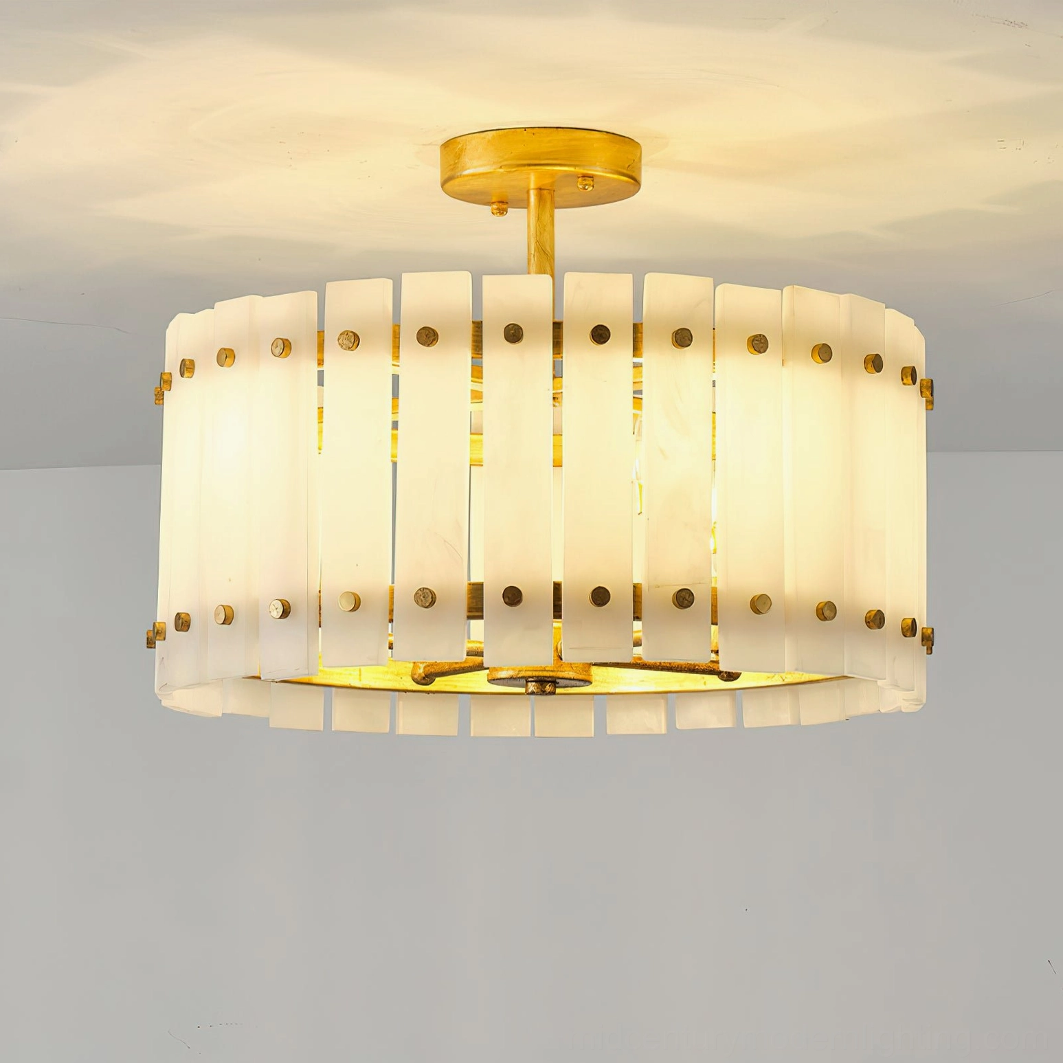 Sinclair alabaster semi-flush ceiling light illuminated at eye-level with warm light glowing through vertical alabaster slats
