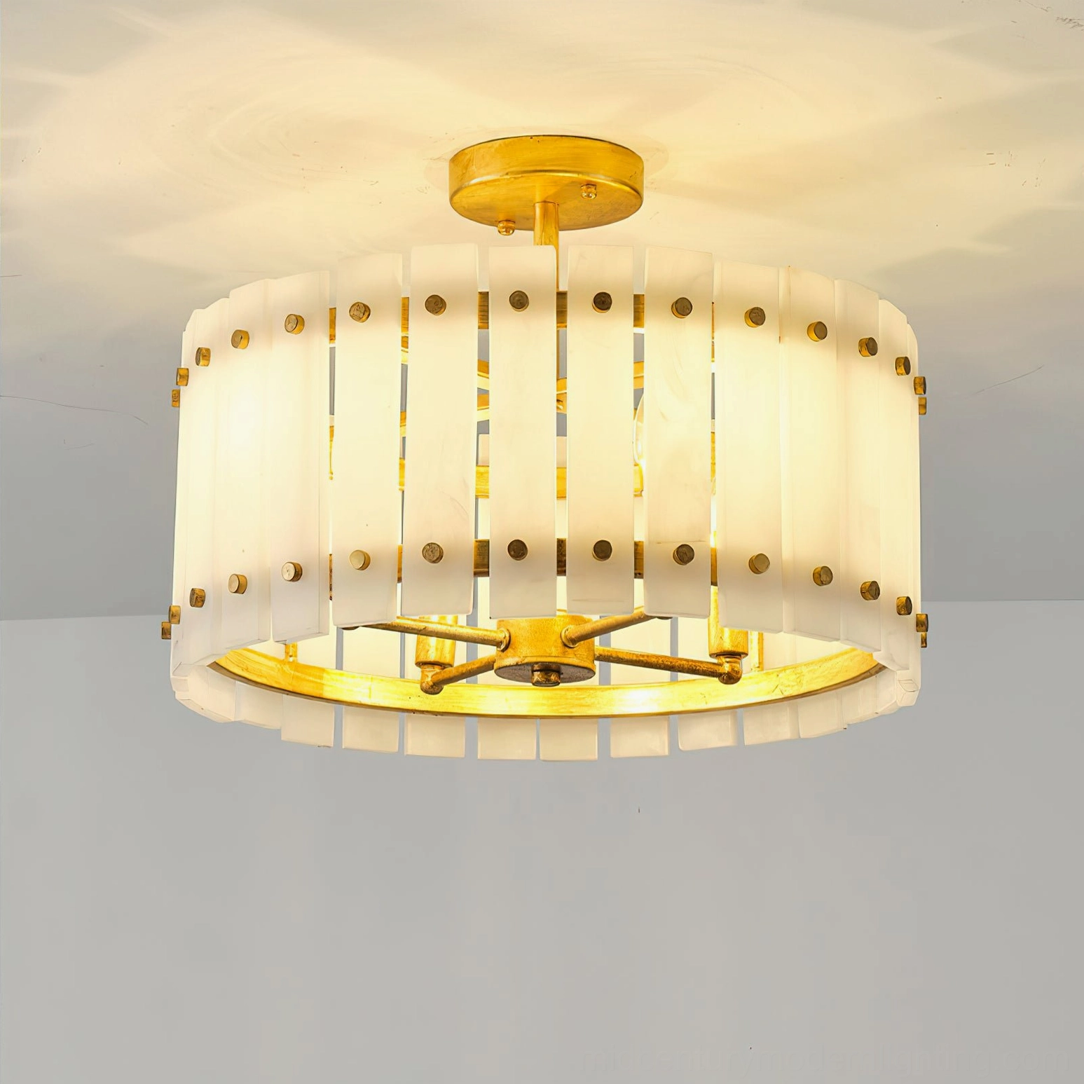 Sinclair alabaster semi-flush ceiling light illuminated casting warm soft shadows through alabaster panels in ceiling installation