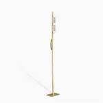 Sinclair polished brass floor lamp with frosted acrylic shade, front view against minimalist white studio background