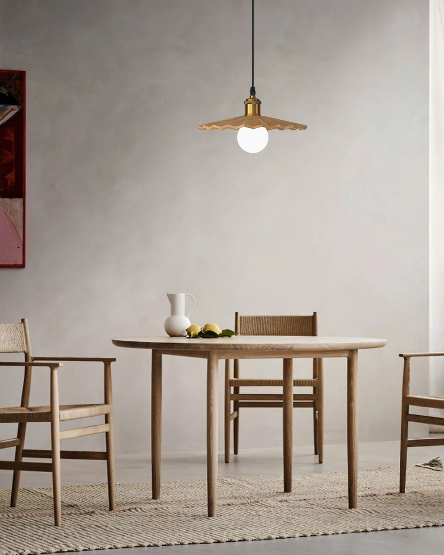 Single geometric walnut pendant light in compact casual dining nook with light wood table and minimalist wall design