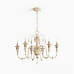 Vintage candelabra chandelier with six ornate carved arms and distressed cream finish, top-down view