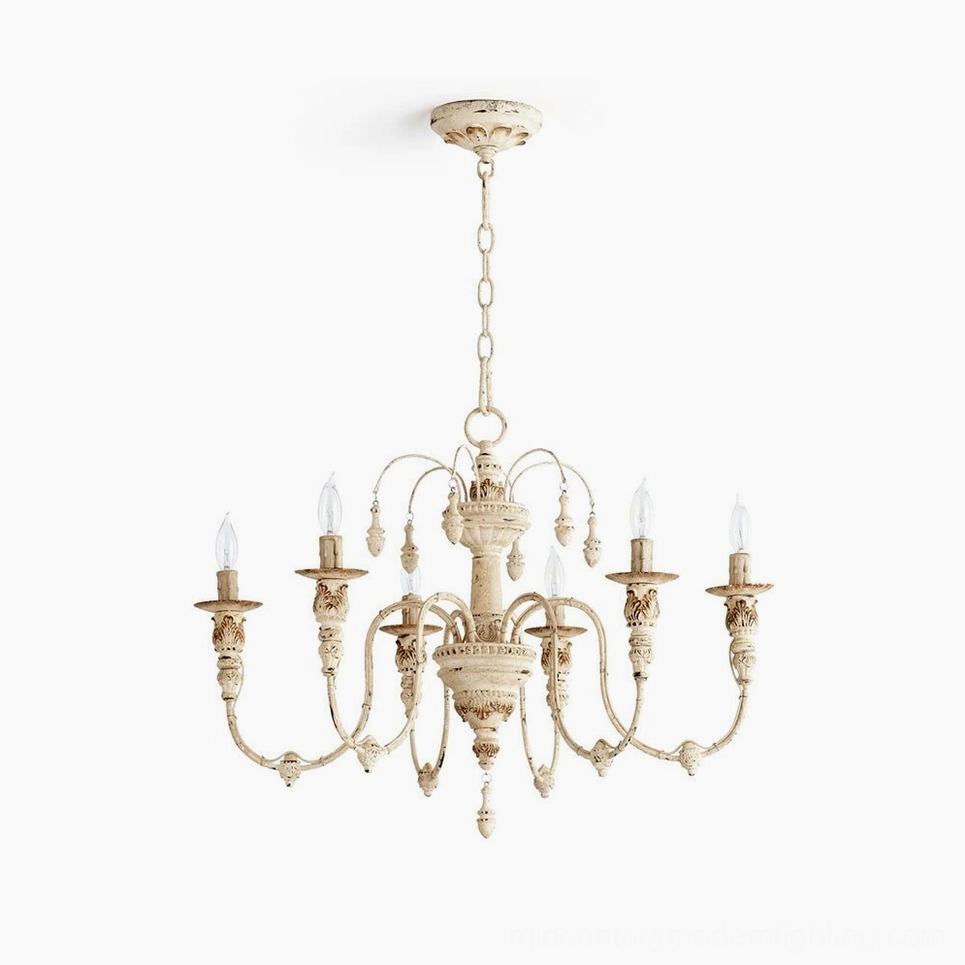 Vintage candelabra chandelier with six ornate carved arms and distressed cream finish, top-down view