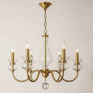 Mid-century modern brass chandelier curved arms clear glass accents front view minimalist