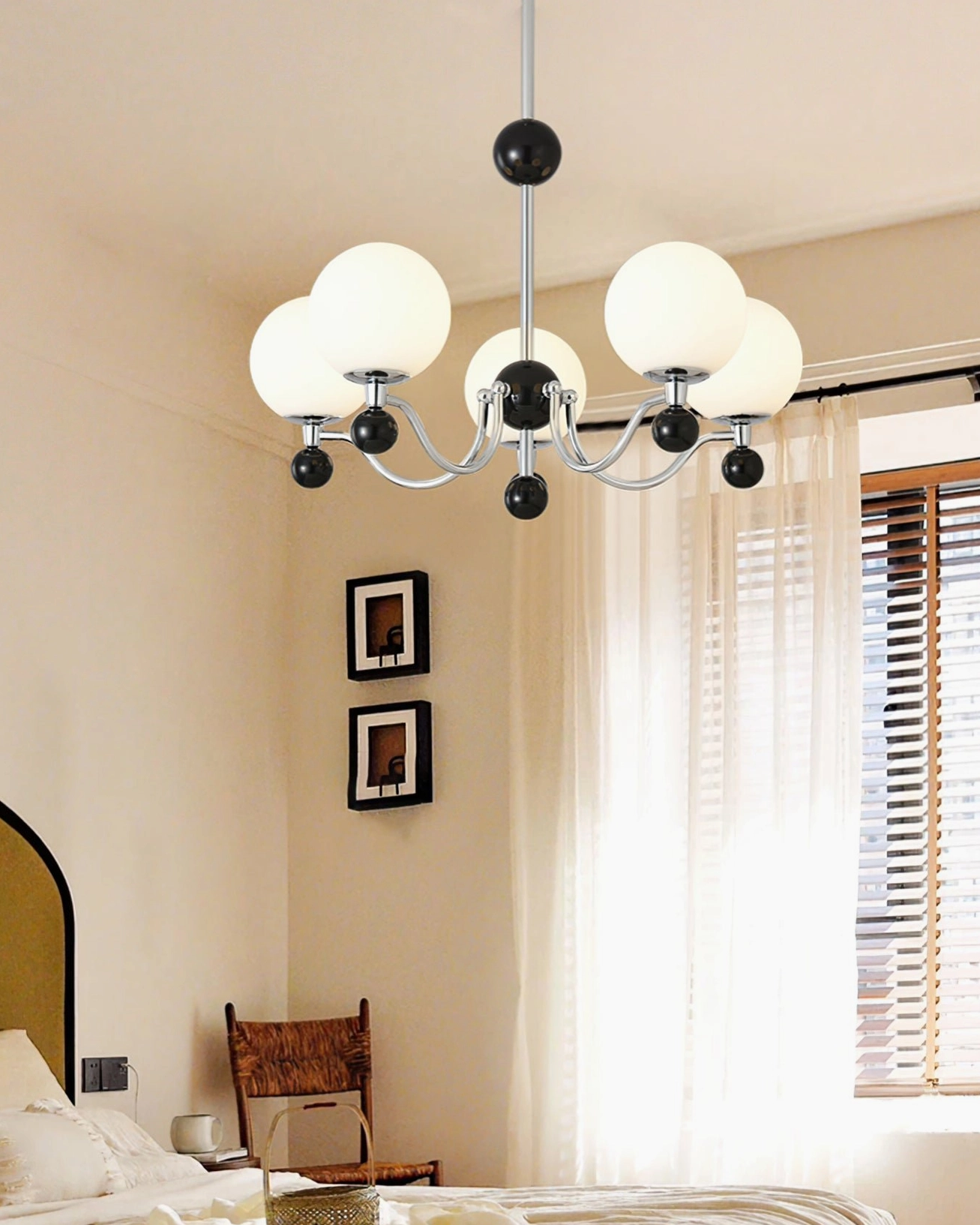 Six-head geometric chandelier with contrasting black white and chrome finishes in cozy warm-toned bedroom