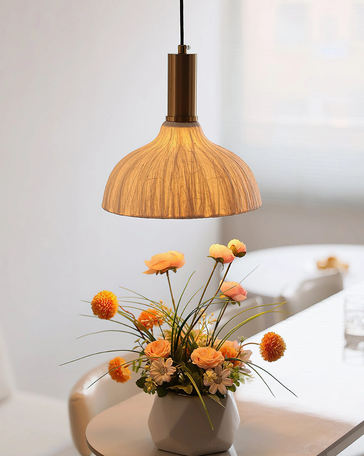 Siya dome pendant with tan ribbed fabric shade and brass hardware over dining table lush floral centerpiece