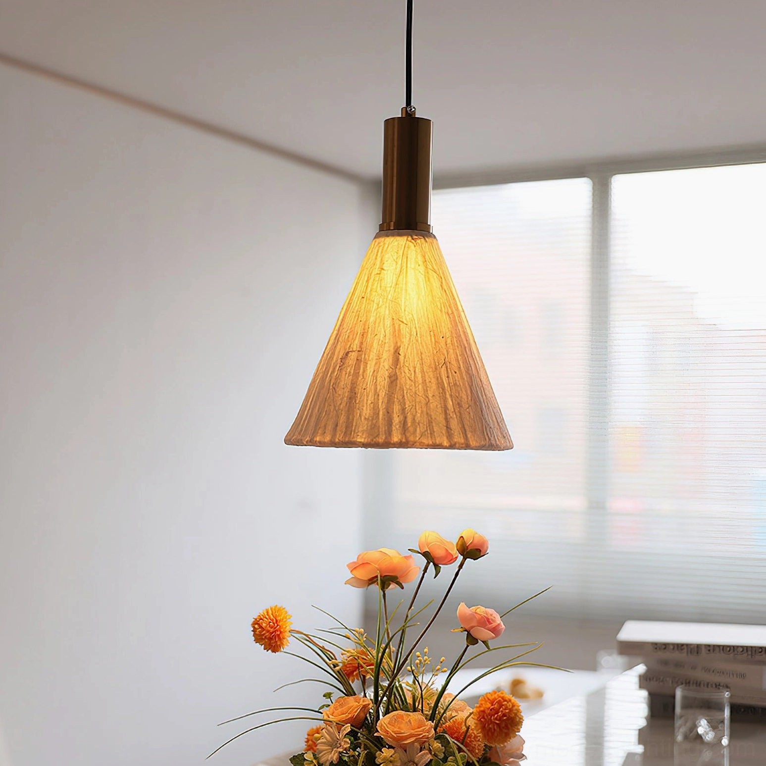 Siya pendant light side view over dining table with floral arrangement, neutral warm bohemian home lighting