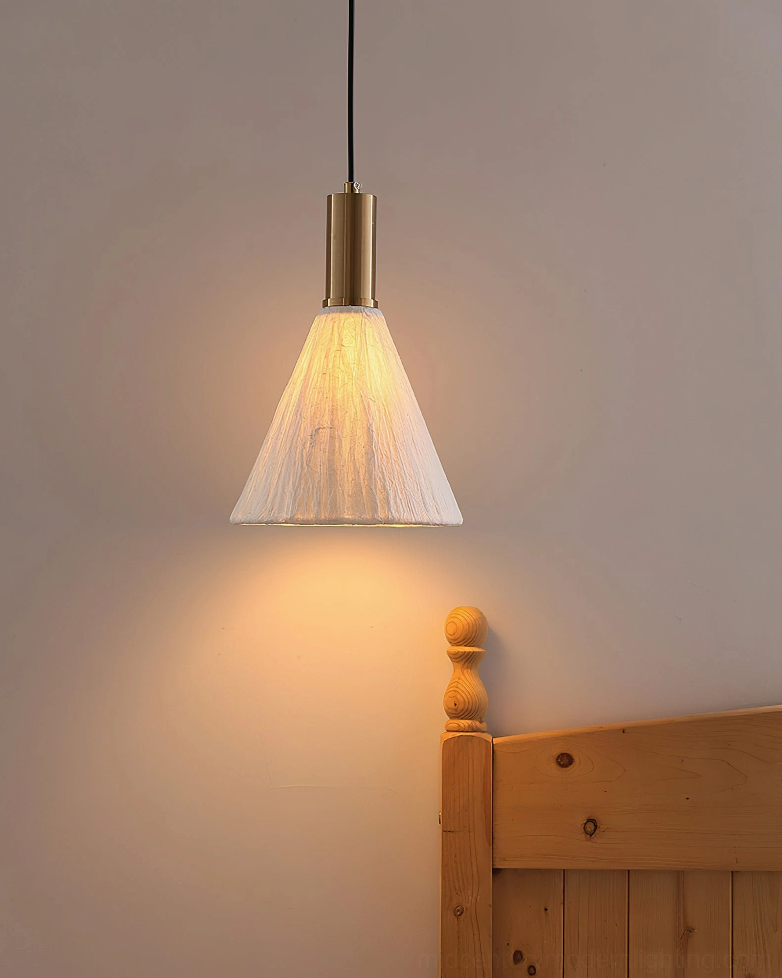 Siya pendant light warm illumination close-up showing paper shade light diffusion and texture