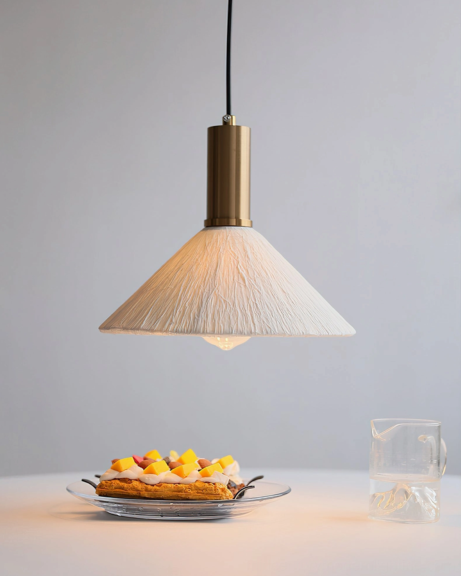 Wide cone fabric Siya pendant light with textured off-white shade over dining table with dessert setup