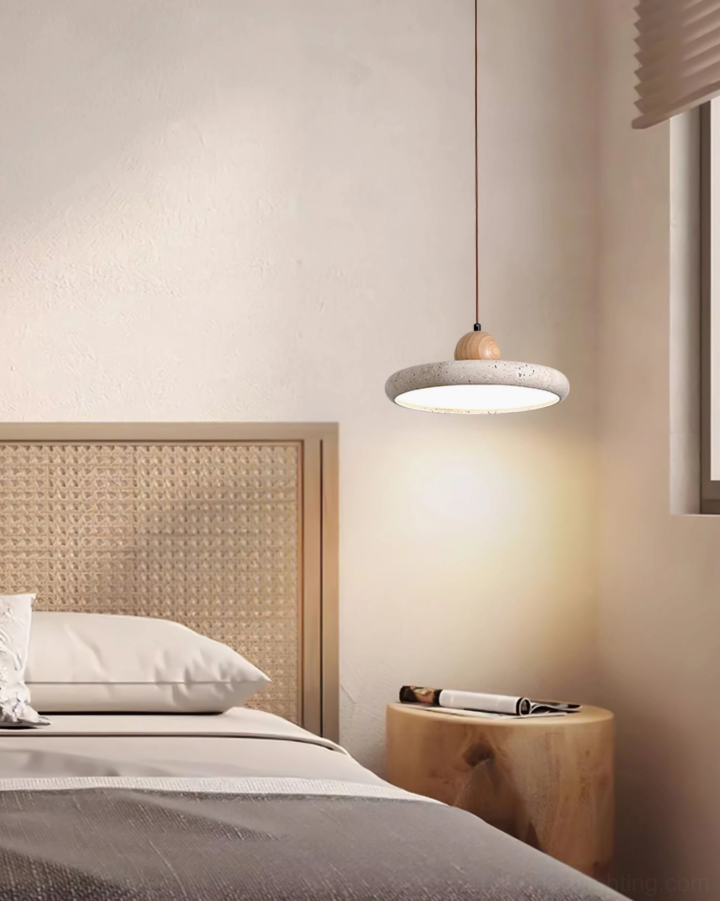 Siyane pendant light creating warm glow in minimalist bedroom with wabi-sabi interior aesthetic
