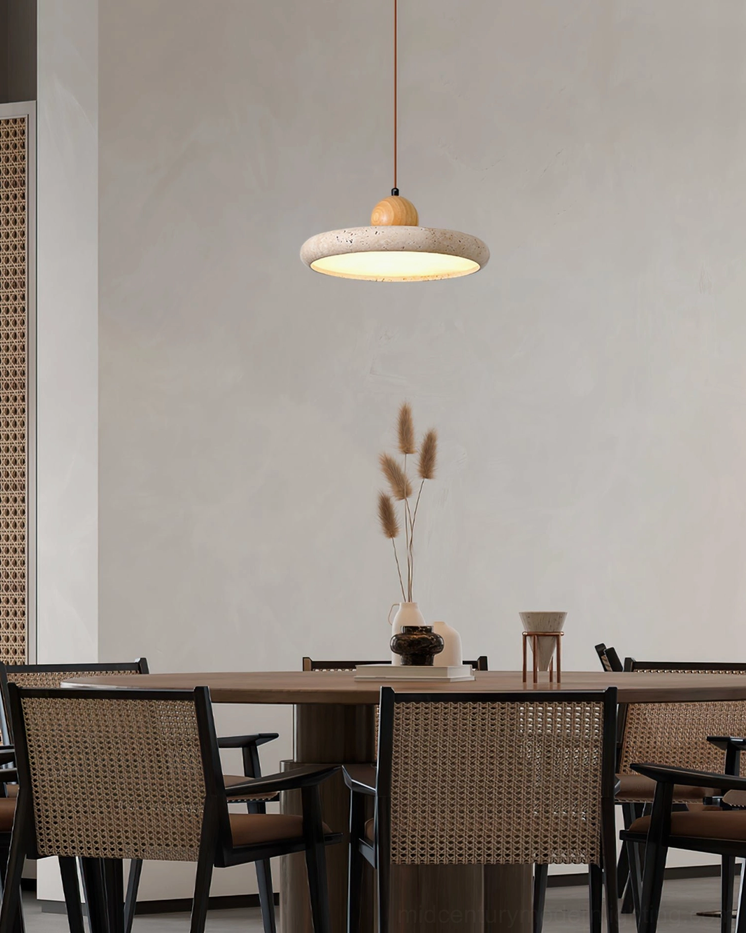 Single Siyane pendant lamp illuminating formal dining room with natural travertine stone shade